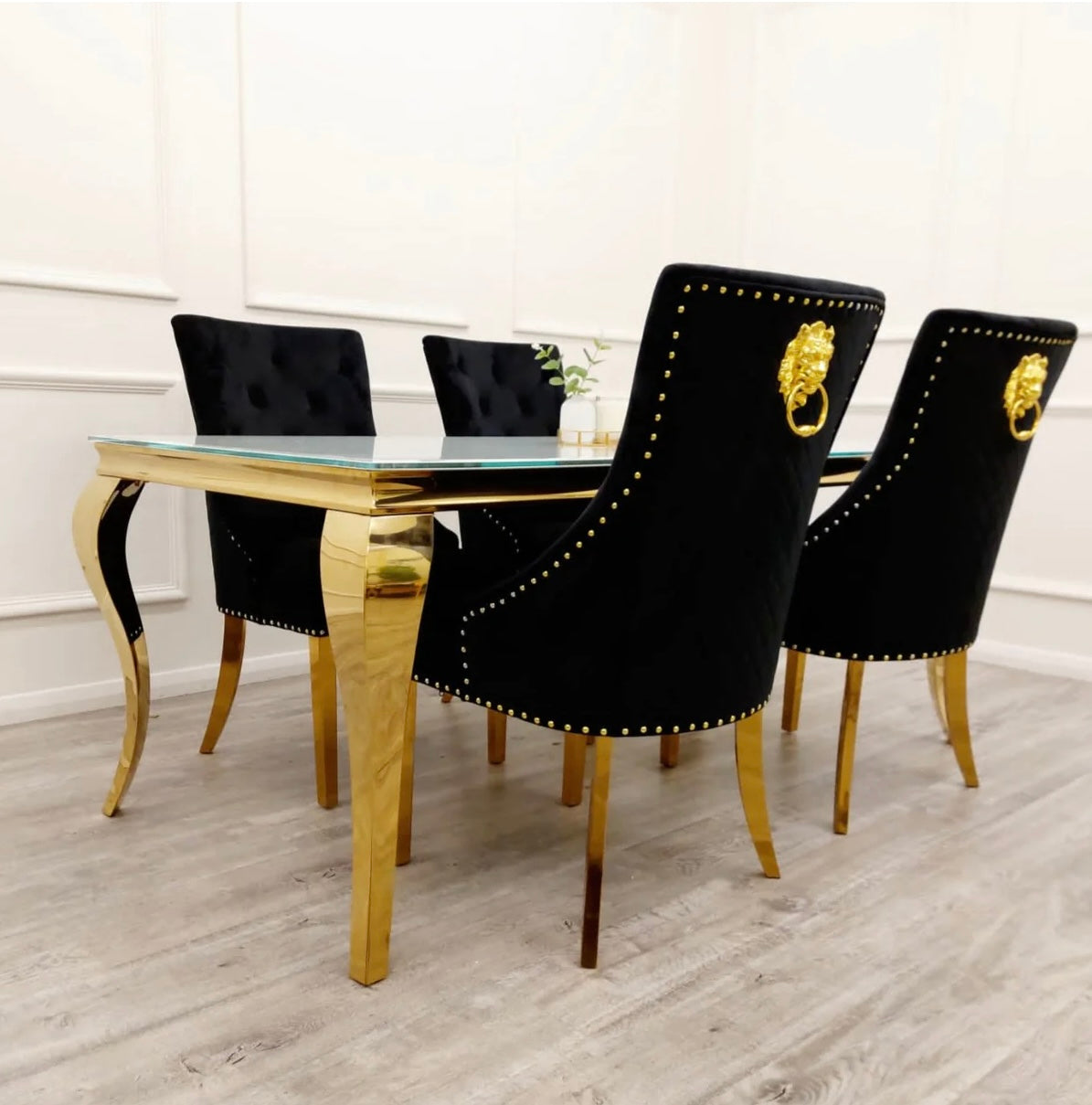 Louis gold white glass dining table with black Bentley chairs